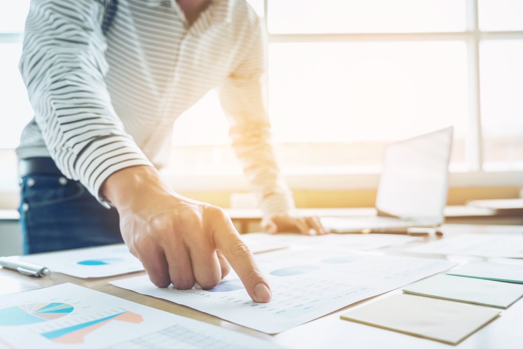 Businessman pointing to financial chart, doing finances and calculate about cost